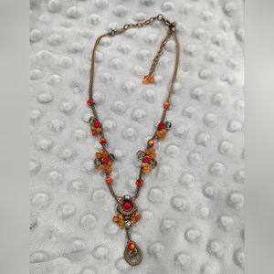 Artisan hand crafted LALY necklace.